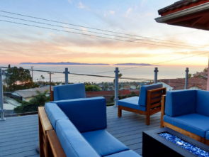 Frameless silver glass railing completes this cozy outdoor living space in San Pedro, CA