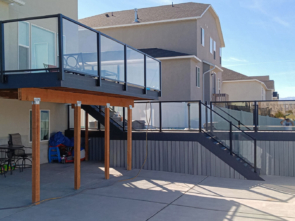 Long shot of all the decks lined with glass railing in this Tooele, UT backyard.